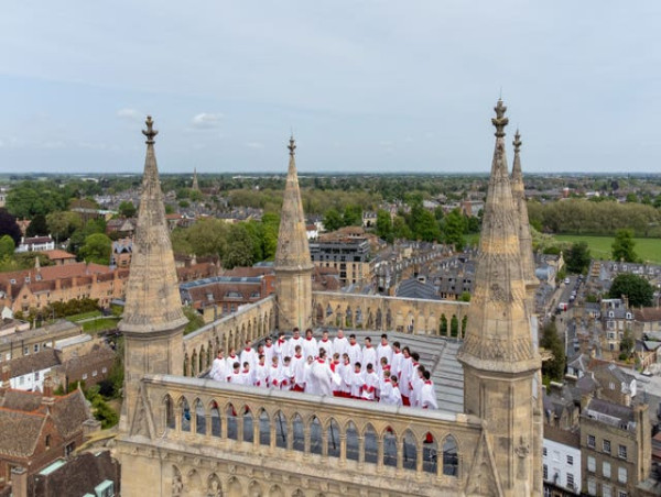  Choir climbs 163ft tower and sings from rooftop in Cambridge college tradition 