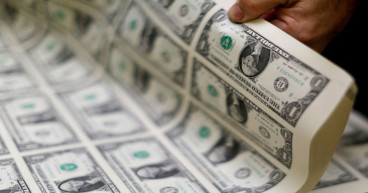 Dollar jumps as wage growth spurs hawkish Fed bets