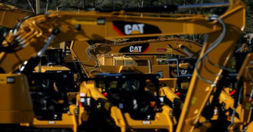 Caterpillar profit slides as costs and forex squeeze margins