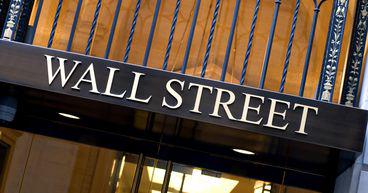 Wall Street declines after hawkish comments; IBM, AT&T surge