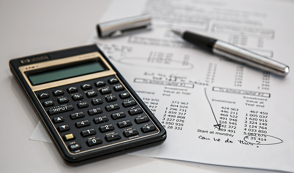 A calculator with a pen