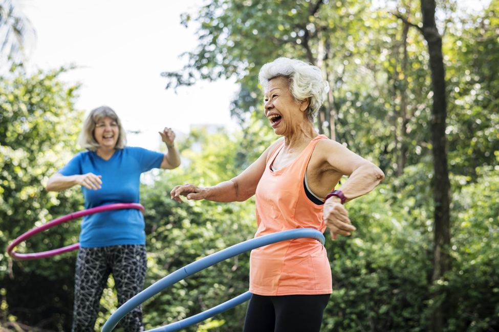 Senior women exercising with hula hoop