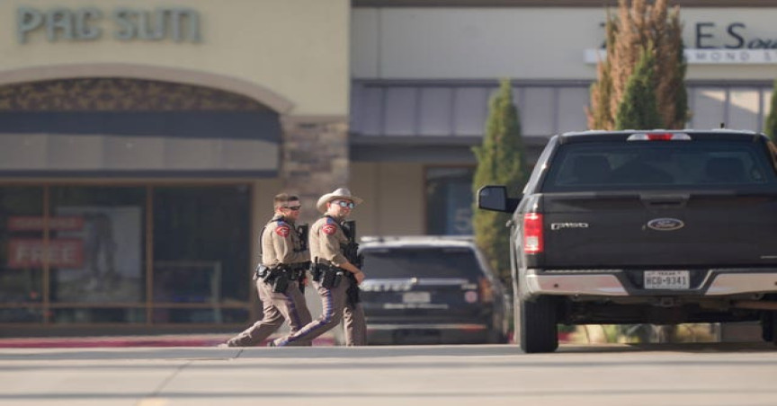 Law enforcement officers patrol a shopping centre after a shooting in Allen, Dallas, Texas