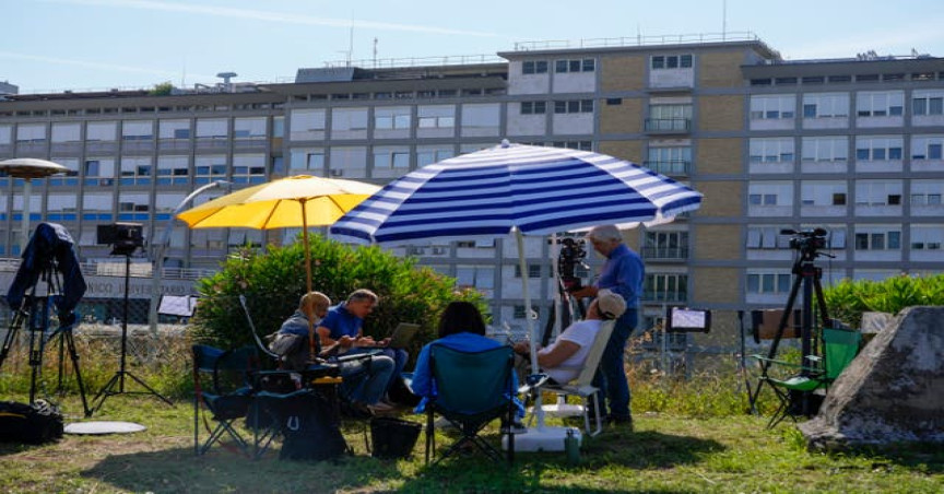 Reporters work in front of Rome’s Agostino Gemelli University Polyclinic