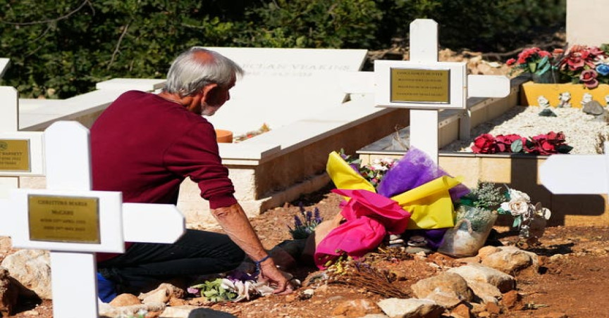 David Hunter lays flowers at the grave of his wife Janice 