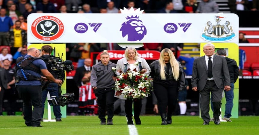 Former Sheffield United player Tony Currie, Sheffield United women’s Sophie Barker and Cusack’s mum and sister laid a wreath in her memory on Sunday (Martin Rickett/PA)