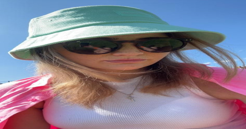 Georgie Cooper wearing a hat and sunglasses