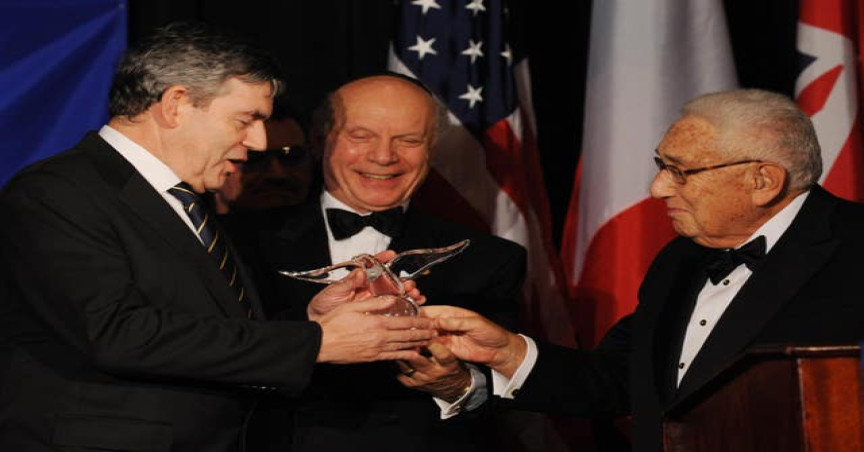 Then prime minister Gordon Brown receiving an award from Mr Kissinger in New York in September 2009