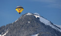  Hot air balloons soar over snowy Swiss town 
