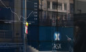 Australian shares edge higher amid earnings reports