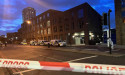  Relatives pray at police cordon after woman fatally stabbed in broad daylight 