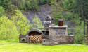 Designing Outdoor Living Areas with Fire Features: Fire Pits and Fireplaces as Functional Focal Points